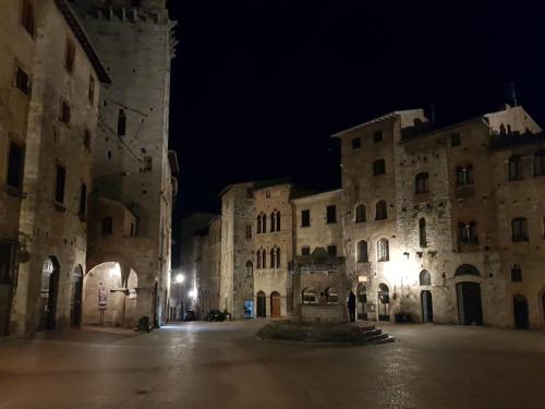 an empty street in an old building at night at Agriturismo Villino del Grillo in San Gimignano