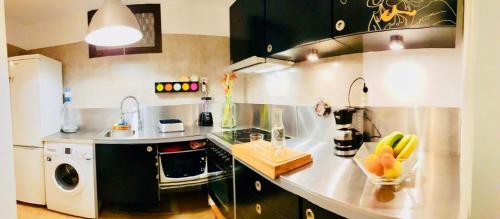 a kitchen with a sink and a stove top oven at Royal Stylish sea view in Los Cristianos