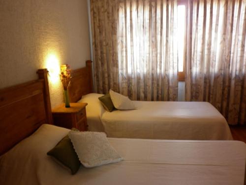 a hotel room with two beds and a window at 816 B&B in Mendoza