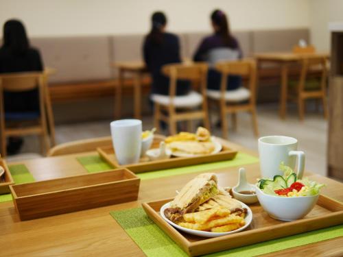 a table with two trays of food on it at See Moon Homestay in Yuchi