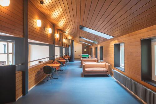 a hallway with chairs and tables in a building at Bern Youth Hostel in Bern