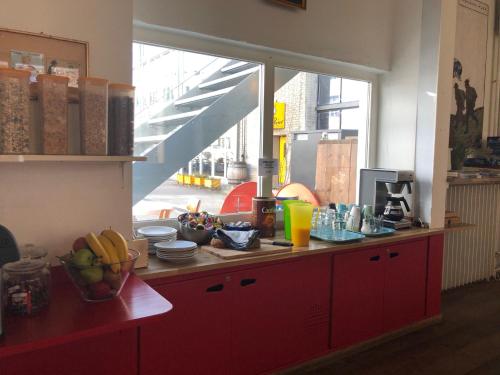 a kitchen with a red counter with fruit on it at Basel Backpack in Basel