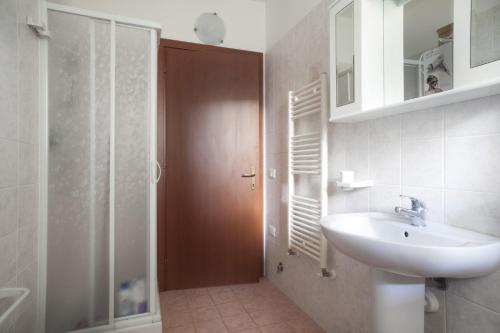 a bathroom with a sink and a glass shower at La Fonte degli Angeli Apartments in Suvereto
