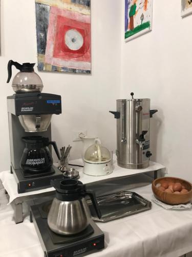 a kitchen counter with a coffee maker and a mixer at Hotel Sole Holiday in Arco