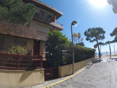 a building with a street light next to a sidewalk at Marina Mar in Platja  d'Aro