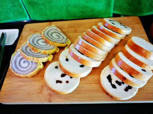 a group of pastries on a wooden cutting board at Borabora B&B in Nanwan