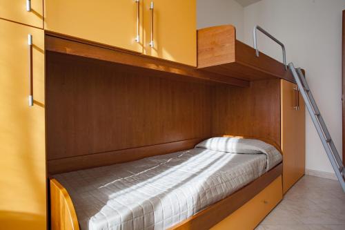 a bedroom with a bunk bed with a ladder at La Fonte degli Angeli Apartments in Suvereto
