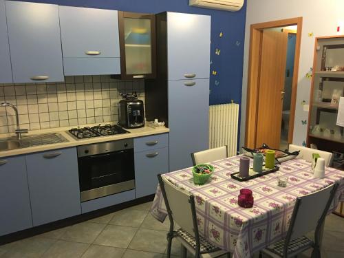 a kitchen with a table with a table cloth on it at B&B Dolce Sogno in SantʼElpidio a Mare