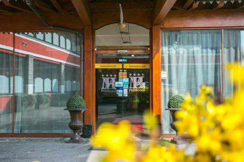 a glass door of a store with flowers in front of it at Primotel Brescia in Brescia