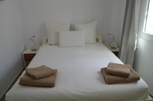 チクラナ・デ・ラ・フロンテーラにあるCasa "El Pinar"のベッドルーム1室(白いベッド1台、タオル2枚付)