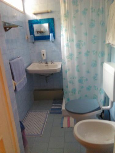 a bathroom with a toilet and a sink at Pensione Santachiara in Sanremo