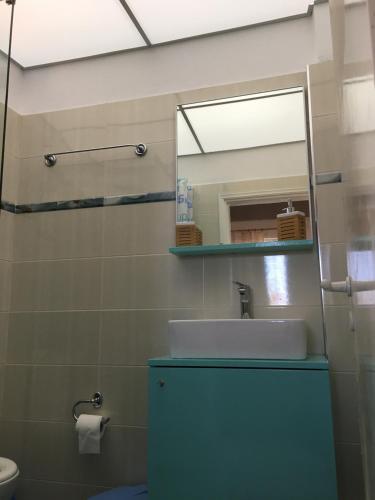 a bathroom with a sink and a mirror at Kastraki Studios in Stoupa