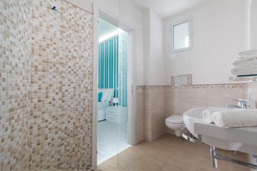 a white bathroom with a sink and a toilet at Villa Iolanda in Piano di Sorrento