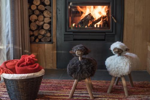 two stuffed animals standing in front of a fireplace at andBeyond Vira Vira in Pucón