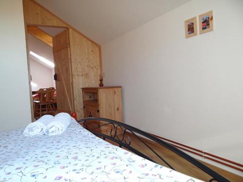 a bedroom with a bed with two towels on it at Farma Růžová in Růžová
