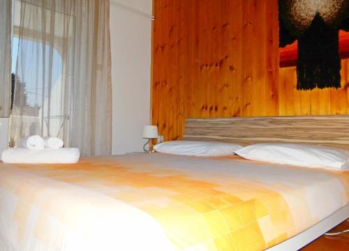 a bedroom with a large bed with a wooden headboard at Petar in Krk