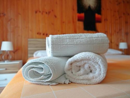 a stack of towels sitting on top of a bed at Petar in Krk