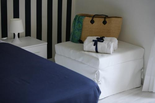 a bedroom with a bed and a chair with towels at Villa Iolanda in Piano di Sorrento