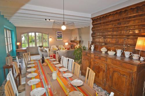 a dining room with a long table and chairs at Mas Antonin in La Garde-Adhémar