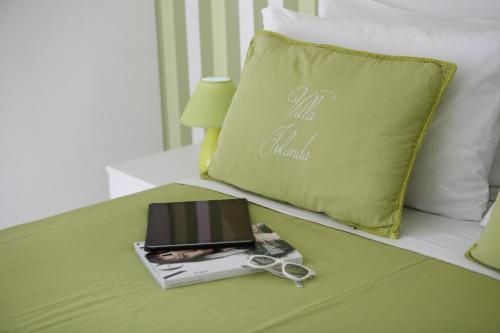 a laptop on a bed next to a pillow at Villa Iolanda in Piano di Sorrento