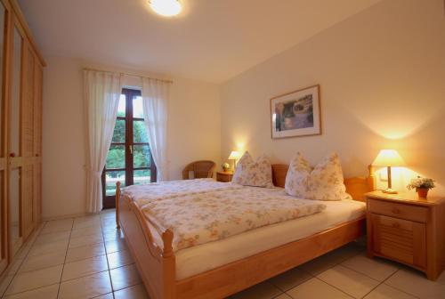 a bedroom with a large bed and a window at FeWo Gudrun in Garmisch-Partenkirchen