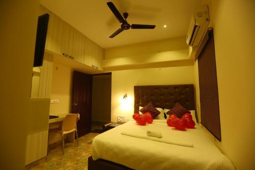 a bedroom with a bed with red bows on it at Zingle Stay Airport Hotel in Chennai