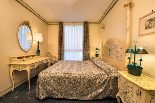 Un ou plusieurs lits dans un hébergement de l'établissement DB Villas Le Ville del Lido Resort
