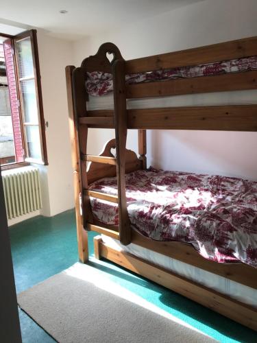 a bedroom with two bunk beds and a window at Chez Daisy in Longefoy