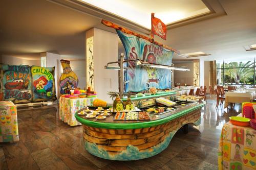 a buffet in a restaurant with food on display at Adrián Hoteles Roca Nivaria in Adeje