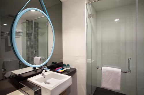 a bathroom with a sink and a mirror at ibis Styles Medan Pattimura in Medan