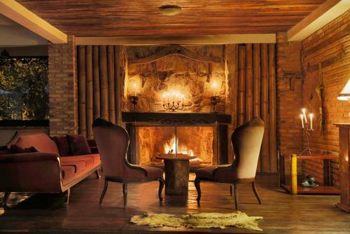 a living room with a couch and a fireplace at Solar dos Ipês in Serra do Cipo