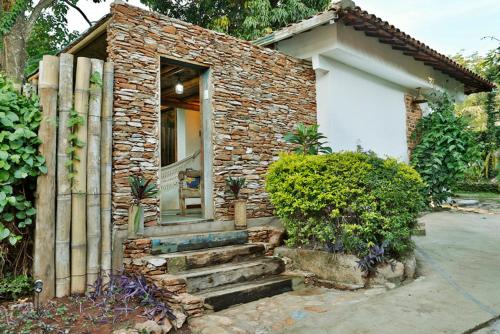 a brick house with stairs leading to a door at Solar dos Ipês in Serra do Cipo
