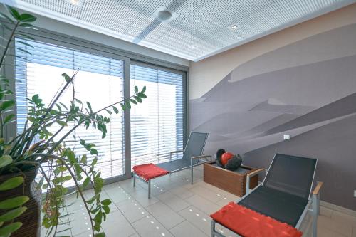 an office with two chairs and a large window at LAGO hotel & restaurant am see in Ulm