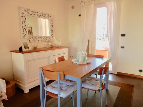 a dining room with a table and chairs and a mirror at Villa Mare in Lido di Camaiore