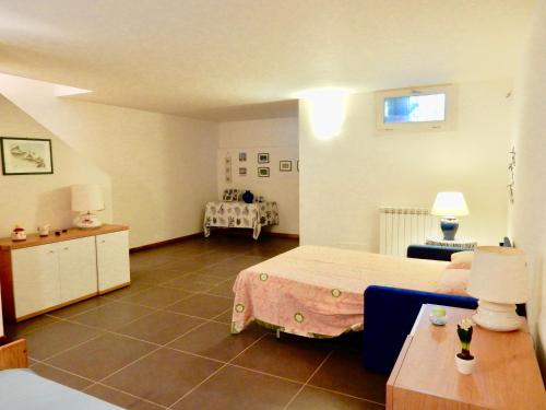 a large room with a bed and a table at Villa Mare in Lido di Camaiore