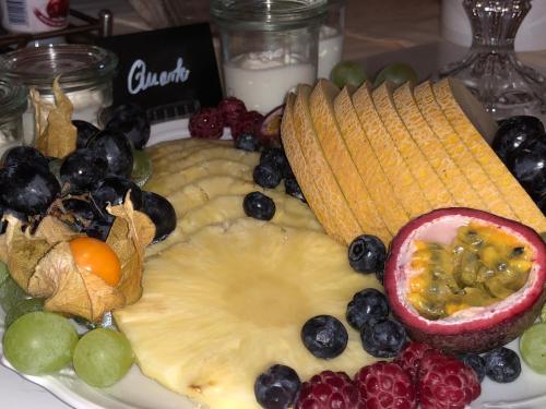 a plate of cheese and fruit on a table at Weingut Bastian in Brauneberg