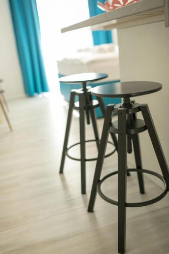 two tables and two stools in a room at Guest House Arsenal Accommodation in Zadar