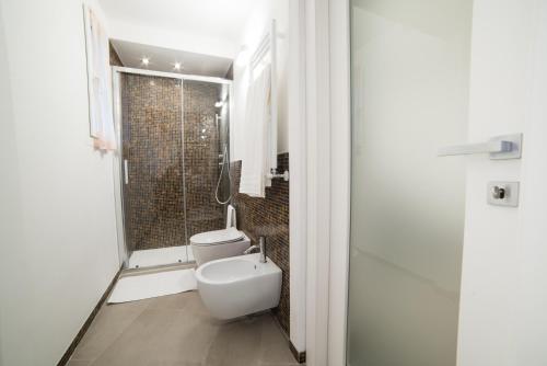 a bathroom with a toilet and a shower at 330 Holiday Apartments Manarola in Manarola