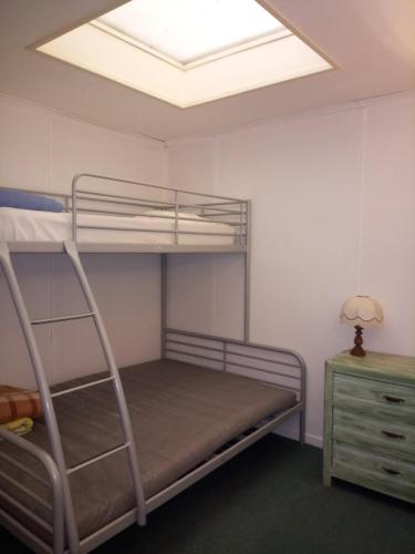 a bedroom with a bunk bed with a skylight at Gîte des Augustins in Monflanquin