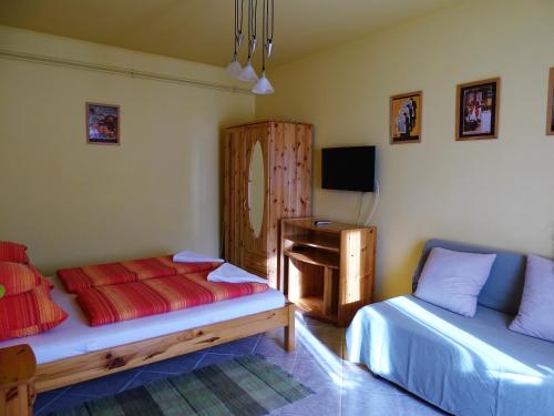 1 dormitorio con 2 camas, escritorio y TV en Franciska Portája en Igal