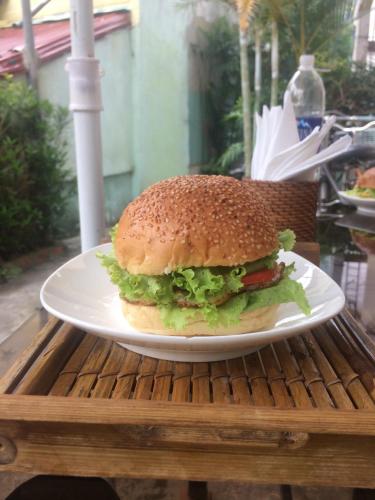 a sandwich on a white plate on a table at Green garden house in Hoi An