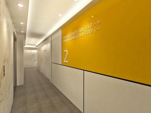 a hallway with a yellow sign on the wall at Talayot - Adults Only in Cala Millor