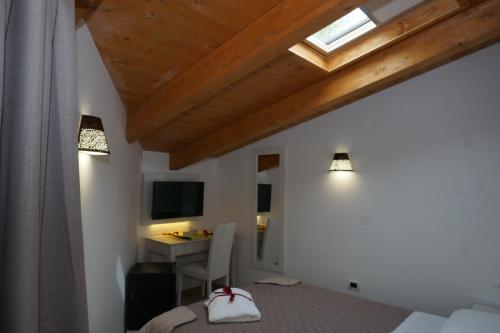 a bedroom with a bed and a desk and a window at San Pietro in Mileto