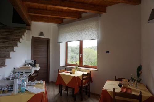 a room with two tables and a window at San Pietro in Mileto