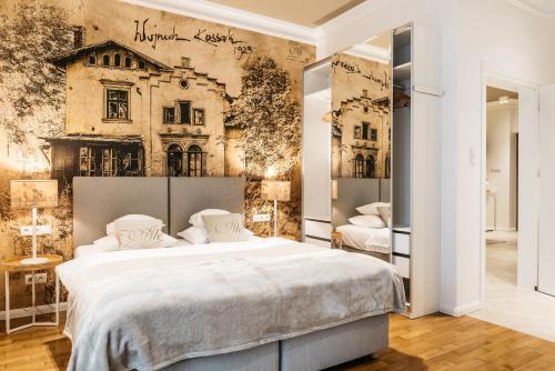 a bedroom with a large bed and a wall with a building at AVANTI Home in Krakow