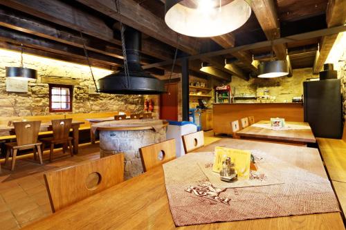 a restaurant with a table and chairs and a kitchen at Porčův mlýn in Býkovice