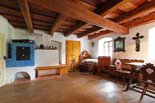 a room with a fireplace and a bed in it at Porčův mlýn in Býkovice