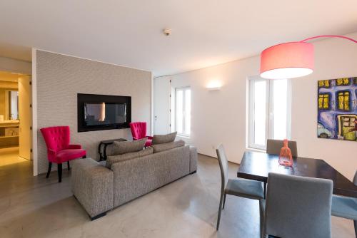 a living room with a couch and a table at Apartments Pateo - Lisbon Lounge Suites in Lisbon
