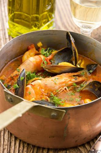 a pan of food with a chicken and mussels at Hotel Restaurant Pusswald in Hartberg