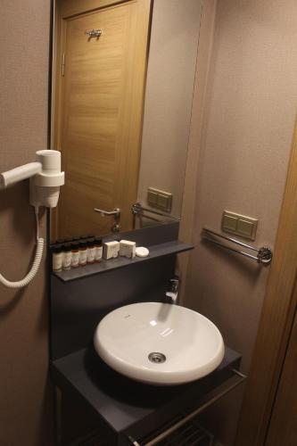 a bathroom with a white sink and a mirror at Endless Comfort Hotel Taksim in Istanbul